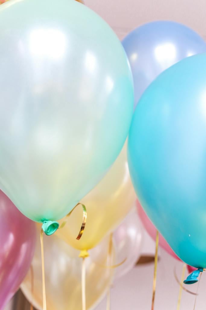 Close-up Photo of Pastel Colored Birthday Balloons